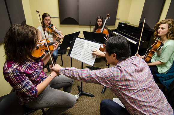 A member of the Shanghai String Quartet working with student ensembles.