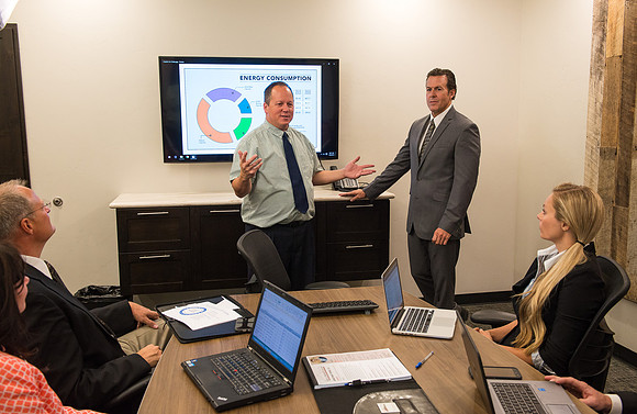 Michael Ballard gives direction for Online Instructor marketing ad. Sean Robertson, acting CEO of boardroom.