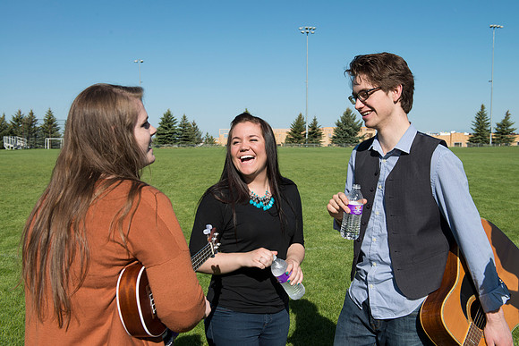 Student models interact and smile for marketing purposes that will be used for the new Campus Housing next to The Ivy.