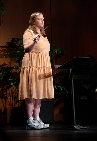 BYU-I student conducting a hymn during devotional.