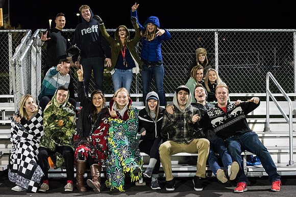 Students come to support their friends on the field.