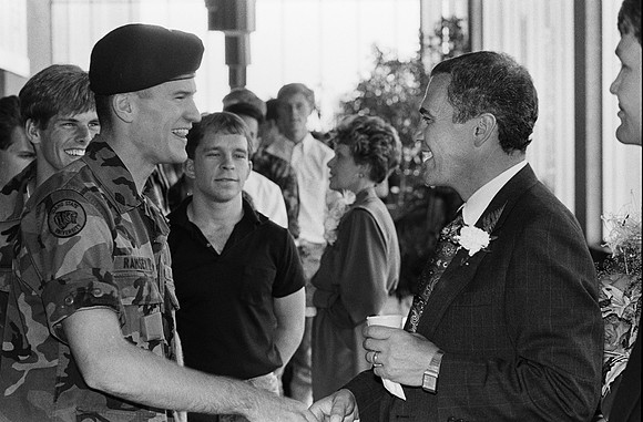 1989, President Steven D. Bennion, President of Ricks College greets students in the foyer of the Hart Building.