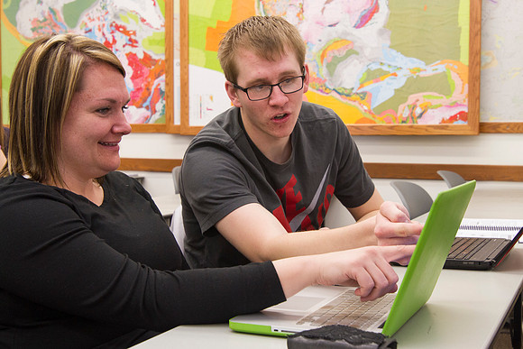 Students help one another in the Productions and Operations Management class taught by Brother Michael Clark.