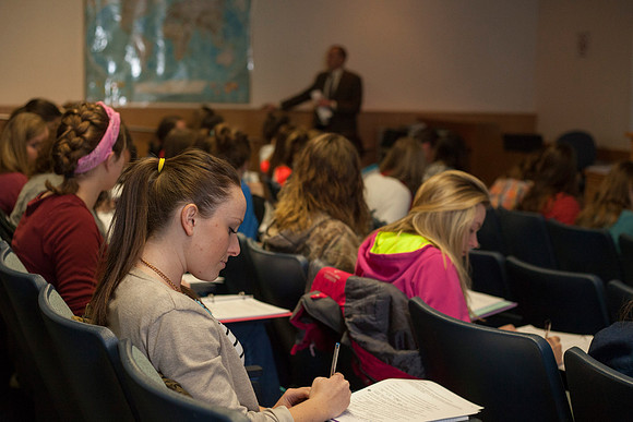 A student from the Geography for Elementary Teachers class, takes notes as Brother Madsen teaches.