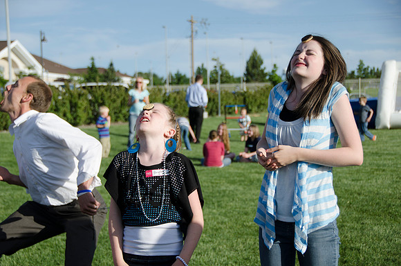 Online instructors gather with their families for an eveing of BBQ and games.