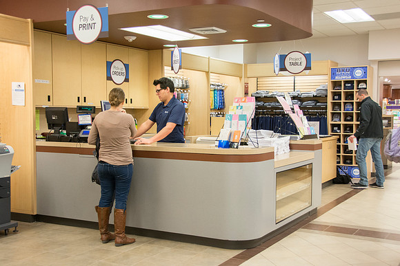 Costumers being helped at service desks.