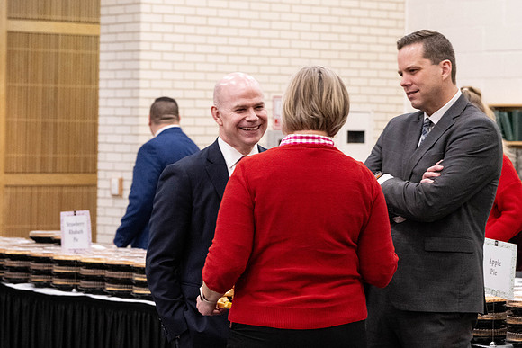 Employees gather for the annual Christmas gathering with President and Sister Meredith.