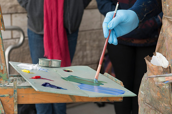 Brother Bodily gives a painting demonstration during his Oil Painting class outside the Spori Building.