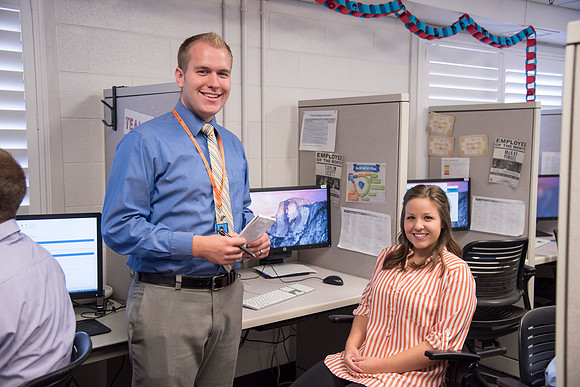 Employees work on developing a better curriculum for online students.