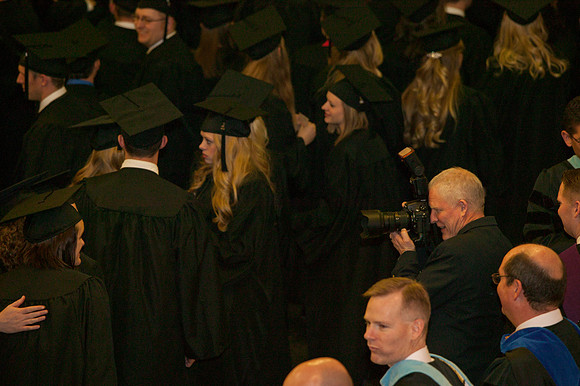 Mike Lewis composes a shot of the graduates as they walking into the I-Center.
