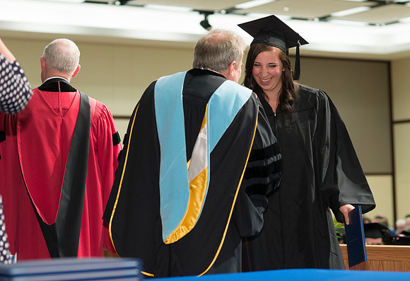 College of Language and Letters Convocation in the Manwaring Center Ballroom. Dean, John Ivers congratulates the graduates.