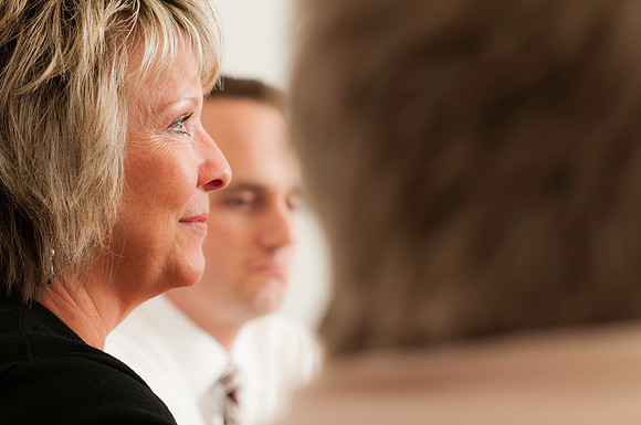 Employees hold a conversation in the Kimball building conference room. Judy Steiner
