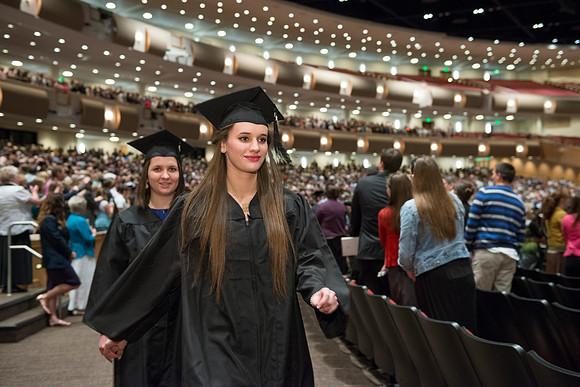 Graduates gather and march in during the processional for April 2014 Graduation ceremonies in the BYU-Idaho Center.