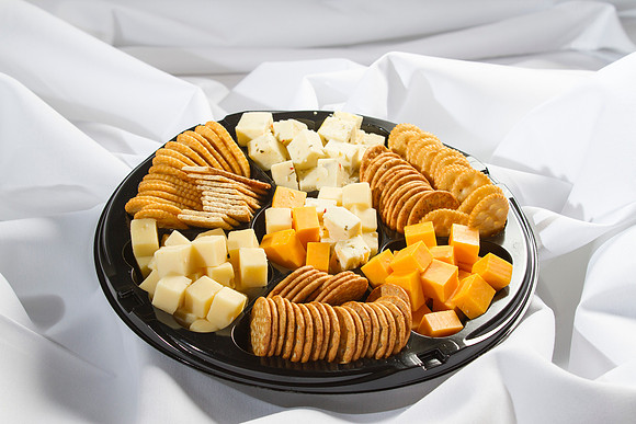 Cheddar, Swiss and Pepper Jack Cheeses Served with a Cracker Medley and Garnished with Grapes.