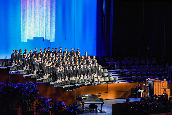 The Men's Choir performs a musical number during devotional, held in the BYU-Idaho Center.