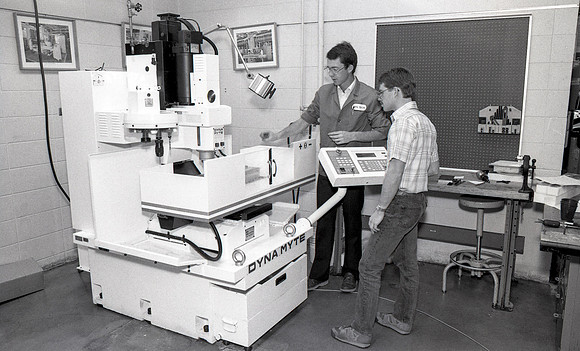 Student works alongside teacher in Manufacturing Technology. December 1990.