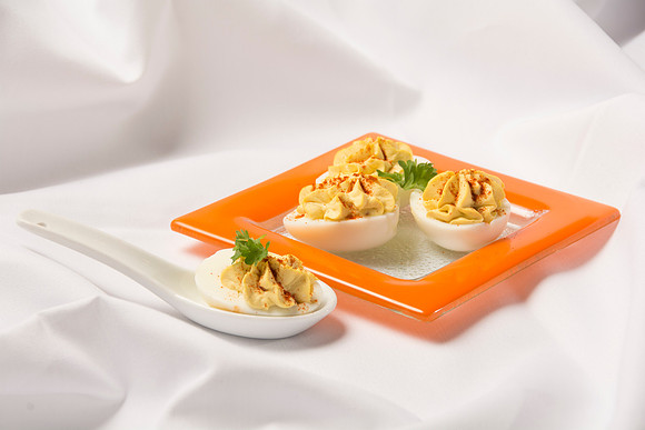 Filled with the hard-bolied egg yolk, mixed with mayonnaise and mustard.