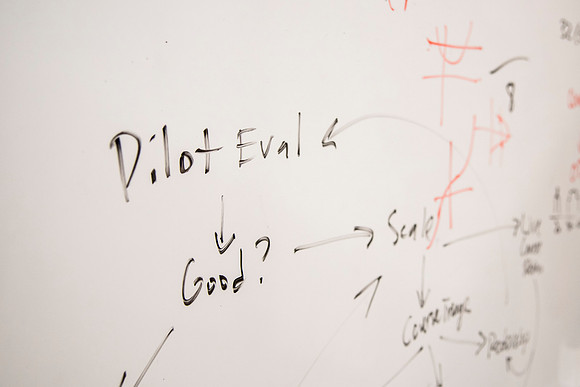 Employees work on developing a better curriculum for online students.