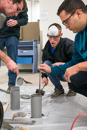 Civil engineering students work with different mixtures of cement to make a light, yet durable, cement that will be the building material for a canoe.