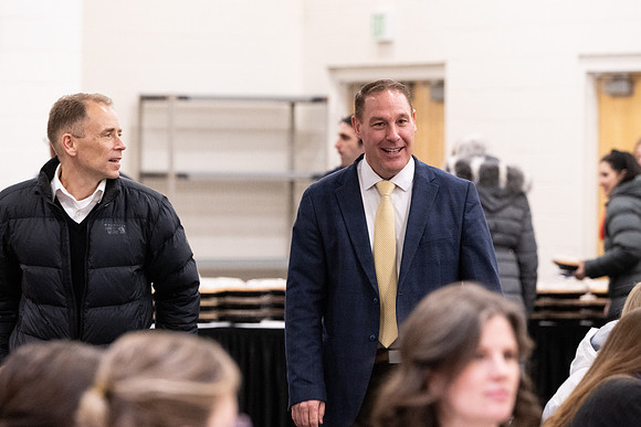 Employees gather for the annual Christmas gathering with President and Sister Meredith.