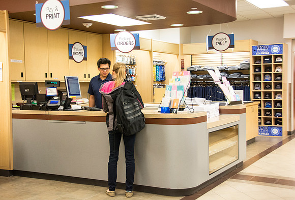 Costumers being helped at service desks.