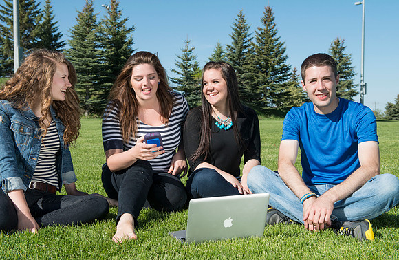 Student models interact and smile for marketing purposes that will be used for the new Campus Housing next to The Ivy.