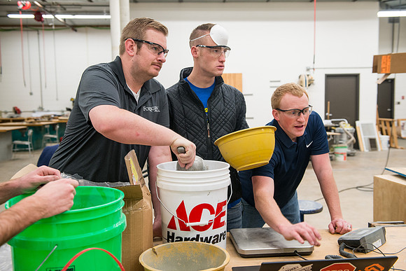 Civil engineering students work with different mixtures of cement to make a light, yet durable, cement that will be the building material for a canoe.