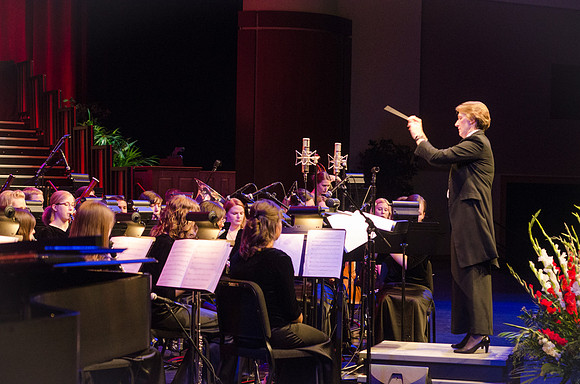 Members of the Collegiate Singers, Men's Choir, Women's Choir, and Symphony Band all perform together at the Patriots and Pioneers Concert.