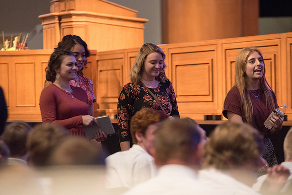 BYU-Idaho Devotional. Guest speaker Elder David A. Bednar and his wife. Students getting ready to listen. Fall Semester