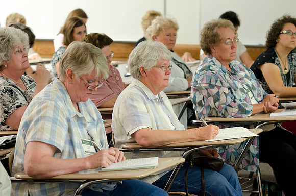 Education Week participants taking notes during class.
