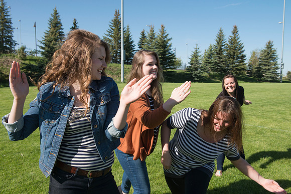 Student models interact and smile for marketing purposes that will be used for the new Campus Housing next to The Ivy.