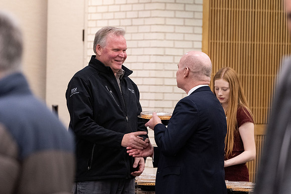 Employees gather for the annual Christmas gathering with President and Sister Meredith.
