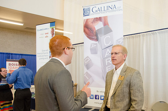 BYU-Idaho students speak to representatives from colleges or companies from their field of study at a career fair held in the I-Center gym
