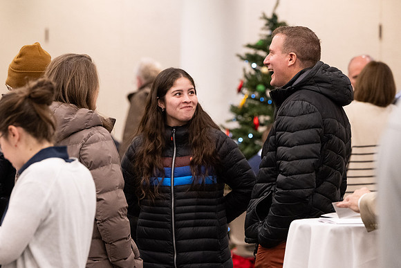 Employees gather for the annual Christmas gathering with President and Sister Meredith.