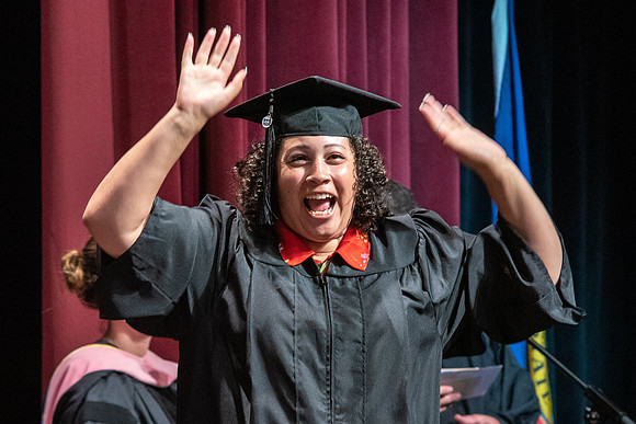 Graduates receiving their diplomas during convocation for the College of Performing and Visual Arts.